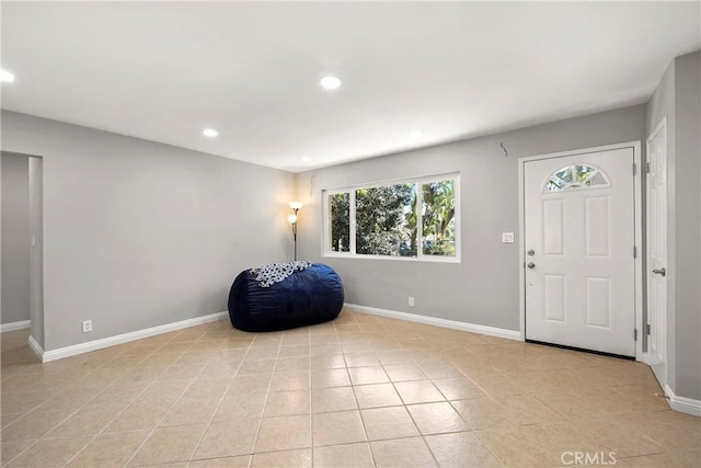 entryway with recessed lighting, baseboards, and light tile patterned floors