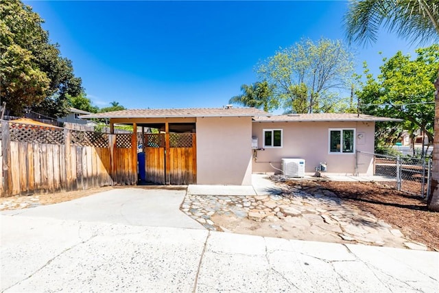 rear view of property with stucco siding, a patio area, and fence private yard