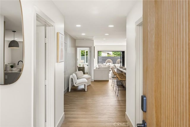 corridor with recessed lighting and light wood finished floors