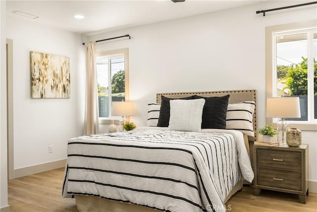 bedroom featuring recessed lighting, light wood finished floors, and baseboards