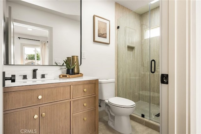 full bathroom with toilet, tile patterned floors, a shower stall, and vanity
