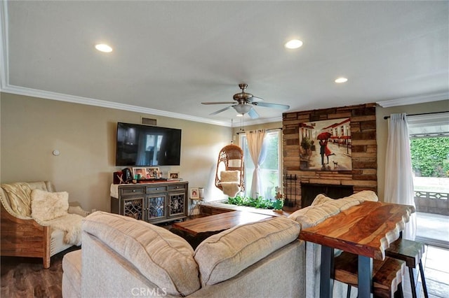 living room with plenty of natural light, crown molding, and a ceiling fan