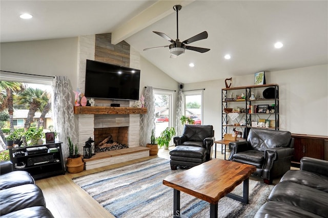 living room featuring lofted ceiling with beams, recessed lighting, wood finished floors, ceiling fan, and a fireplace