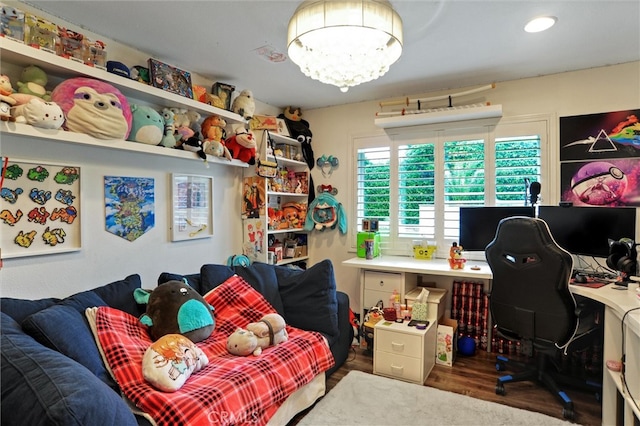 bedroom with a chandelier and wood finished floors