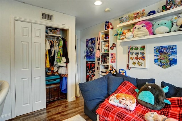 bedroom with recessed lighting, wood finished floors, visible vents, and a closet