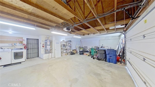 garage featuring washer and clothes dryer, strapped water heater, and a garage door opener