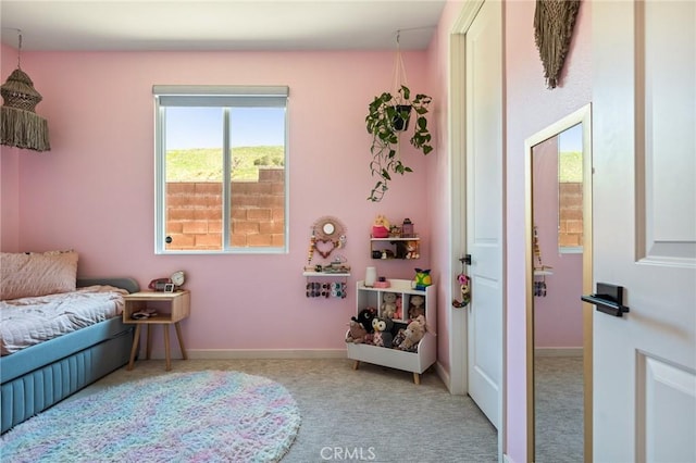 carpeted bedroom featuring baseboards
