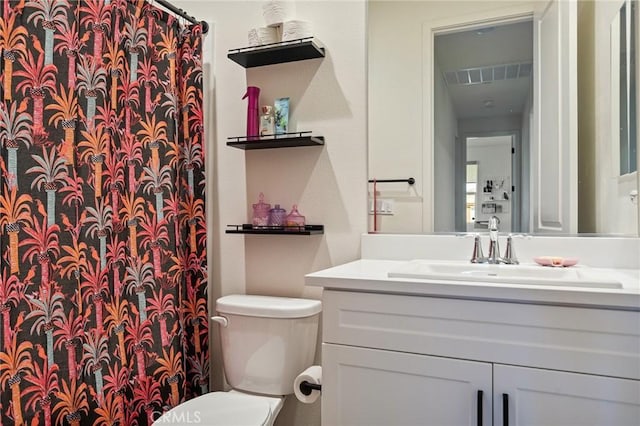 bathroom featuring vanity, visible vents, and toilet