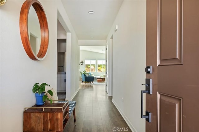 hallway with baseboards, recessed lighting, and dark wood finished floors