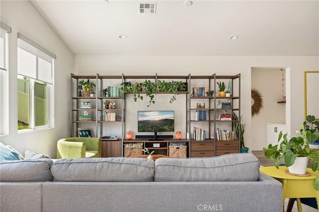 living area with recessed lighting and visible vents