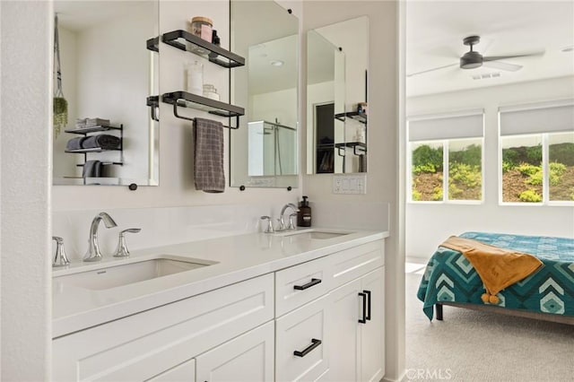 full bath with a shower with door, double vanity, visible vents, and a sink