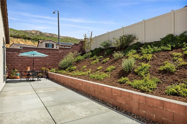 view of patio featuring a fenced backyard and outdoor dining area