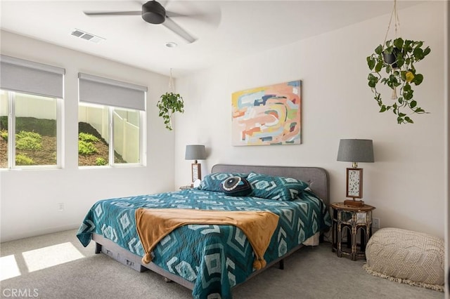 bedroom with visible vents, ceiling fan, and carpet flooring