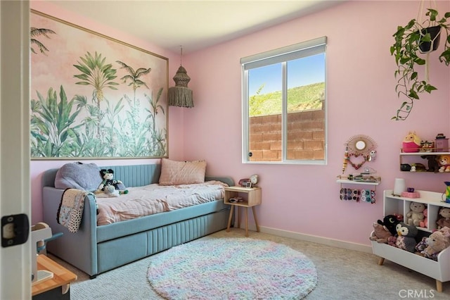 carpeted bedroom featuring baseboards