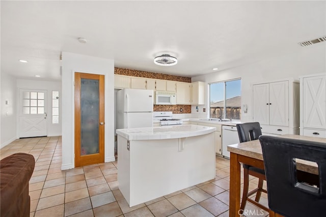 27304 Mystical Springs Dr, Corona, CA 92883 - kitchen featuring white appliances, tile countertops, a center island, recessed lighting, and light tile patterned flooring