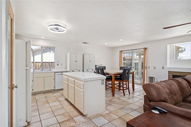 27304 Mystical Springs Dr, Corona, CA 92883 - kitchen featuring white appliances, open floor plan, a ceiling fan, a center island, and light tile patterned flooring