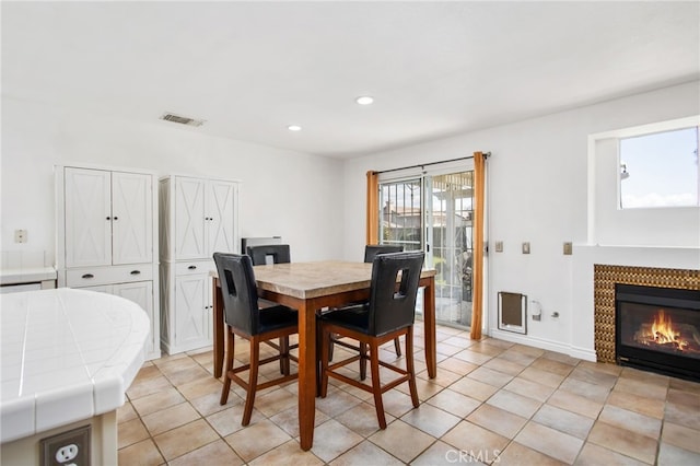 27304 Mystical Springs Dr, Corona, CA 92883 - dining room with light tile patterned floors, a tiled fireplace, and recessed lighting