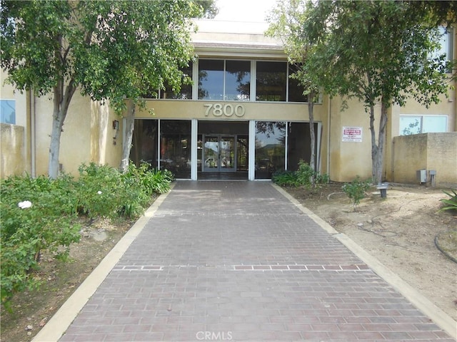 entrance to property featuring stucco siding