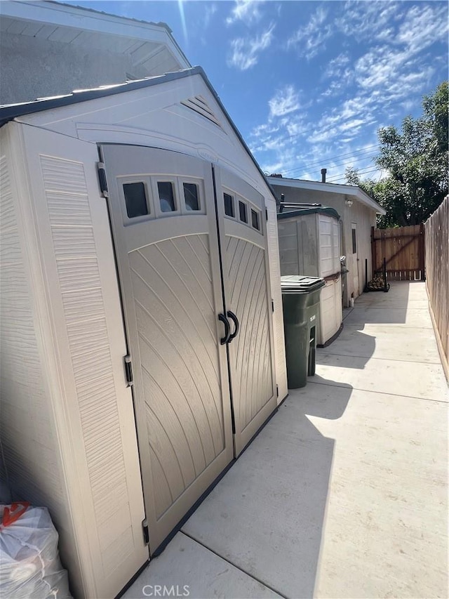 view of shed featuring fence