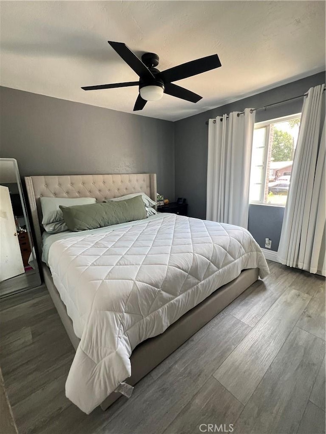 bedroom featuring a ceiling fan and wood finished floors