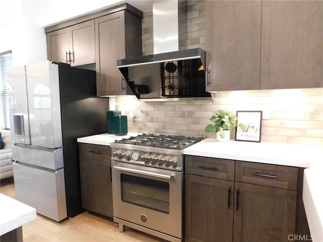 772 Francesca Dr, Walnut, CA 91789 - kitchen featuring appliances with stainless steel finishes, wall chimney exhaust hood, backsplash, and light countertops