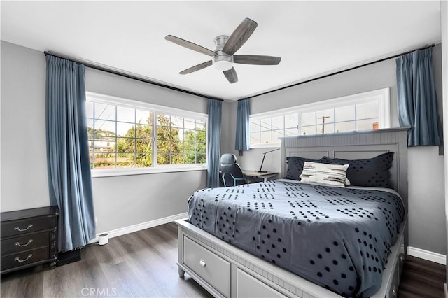 bedroom with dark wood-type flooring, baseboards, and a ceiling fan