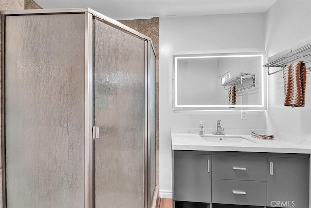full bathroom featuring a shower stall and vanity
