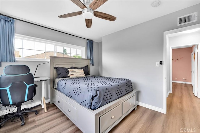 bedroom with light wood-style flooring, ceiling fan, baseboards, and visible vents