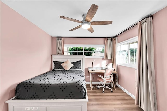 bedroom featuring light wood-style flooring, ceiling fan, and baseboards