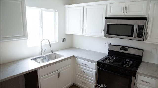 kitchen featuring a sink, white cabinetry, and stainless steel appliances