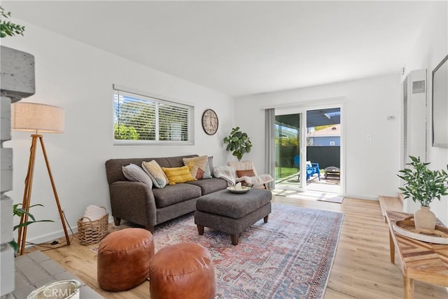living room with baseboards and light wood finished floors