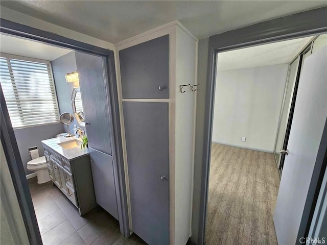 6979 Palm Ct Unit 126H, Riverside, CA 92506 - bathroom featuring tile patterned floors, toilet, and vanity