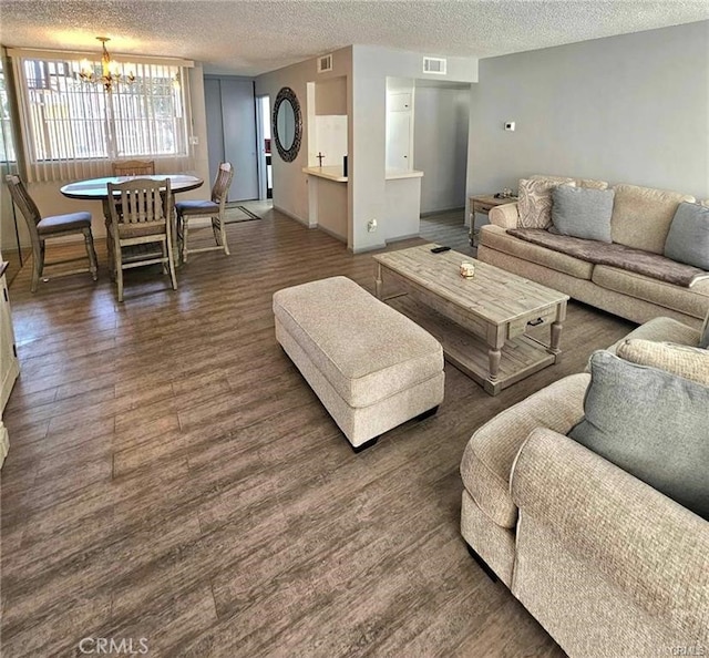 6979 Palm Ct Unit 126H, Riverside, CA 92506 - living room with visible vents, a chandelier, wood finished floors, and a textured ceiling