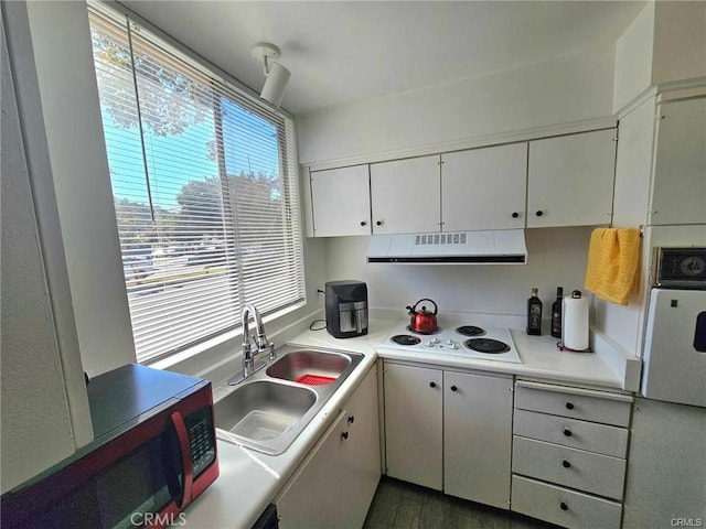 6979 Palm Ct Unit 126H, Riverside, CA 92506 - kitchen with white cabinets, a sink, light countertops, white electric cooktop, and extractor fan