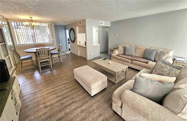 6979 Palm Ct Unit 126H, Riverside, CA 92506 - living room with a notable chandelier, a textured ceiling, visible vents, and wood finished floors