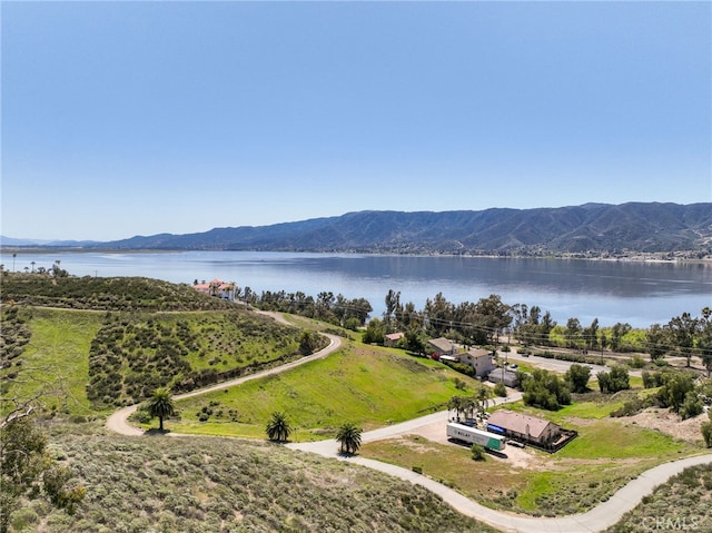 birds eye view of property with a water and mountain view