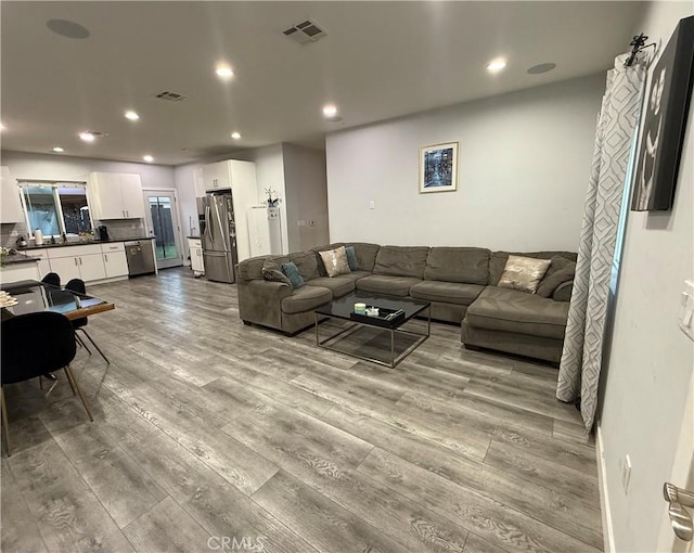 14615 Wyandotte St, Van Nuys, CA 91405 - living area featuring recessed lighting, visible vents, and wood finished floors