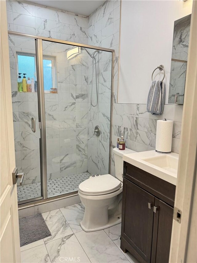 14615 Wyandotte St, Van Nuys, CA 91405 - bathroom featuring vanity, tile walls, toilet, a marble finish shower, and marble finish floor