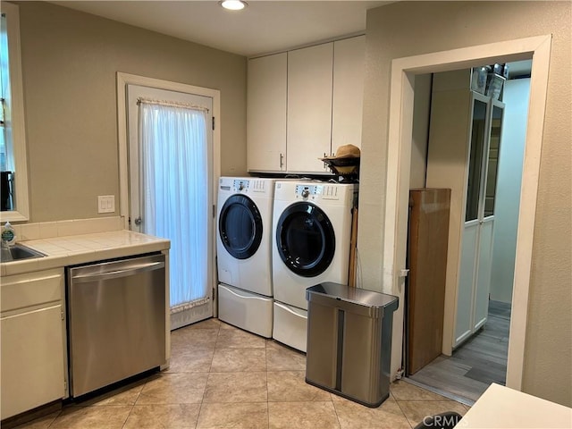 14615 Wyandotte St, Van Nuys, CA 91405 - washroom with separate washer and dryer, light tile patterned flooring, cabinet space, and recessed lighting