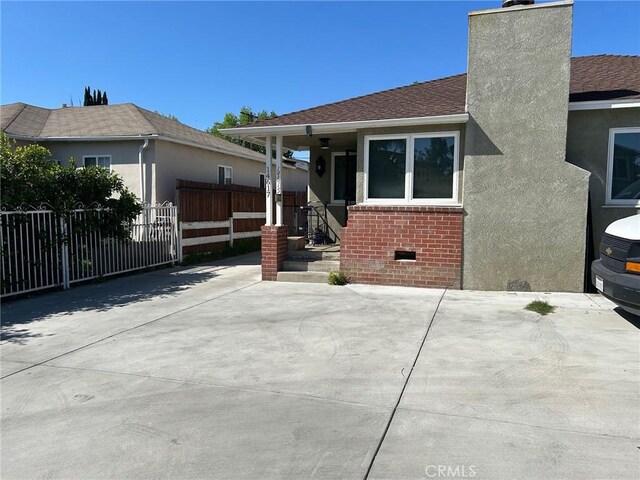 14615 Wyandotte St, Van Nuys, CA 91405 - exterior space featuring crawl space, stucco siding, fence, brick siding, and a chimney
