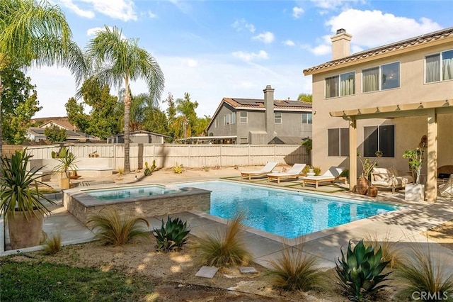 view of pool featuring a fenced backyard, an in ground hot tub, a fenced in pool, and a patio