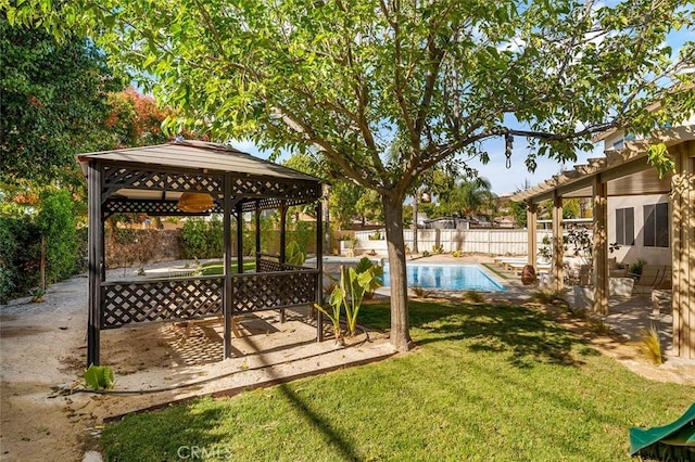 view of yard with a fenced in pool, a gazebo, a patio area, and a fenced backyard