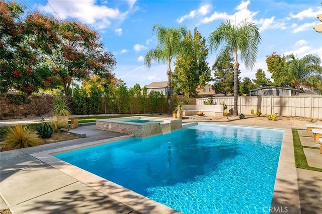 view of pool with a fenced backyard, a pool with connected hot tub, and a patio area
