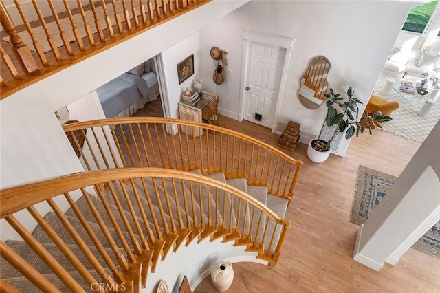 stairway with baseboards and wood finished floors