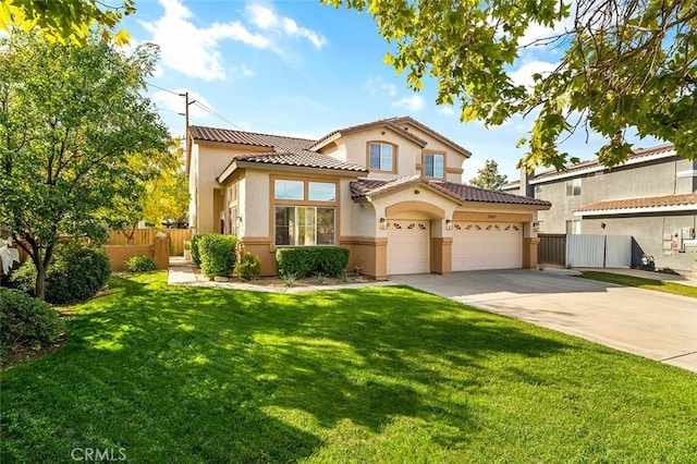 mediterranean / spanish-style house with a tile roof, fence, stucco siding, a front lawn, and driveway