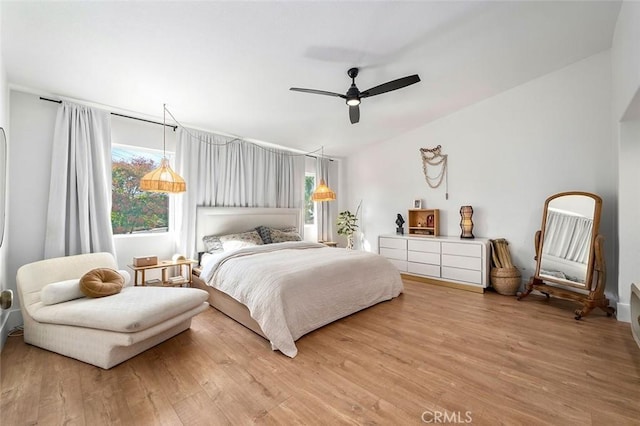 bedroom with light wood-style flooring, ceiling fan, and lofted ceiling