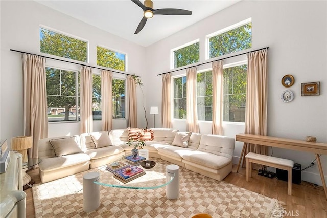 living room with a ceiling fan and wood finished floors