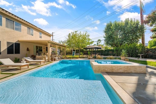 view of pool with a patio, a gazebo, a fenced in pool, and an in ground hot tub
