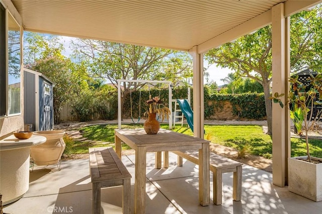 view of patio / terrace with a fenced backyard and a playground