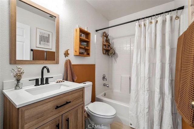 bathroom featuring toilet, vanity, and shower / bath combination with curtain